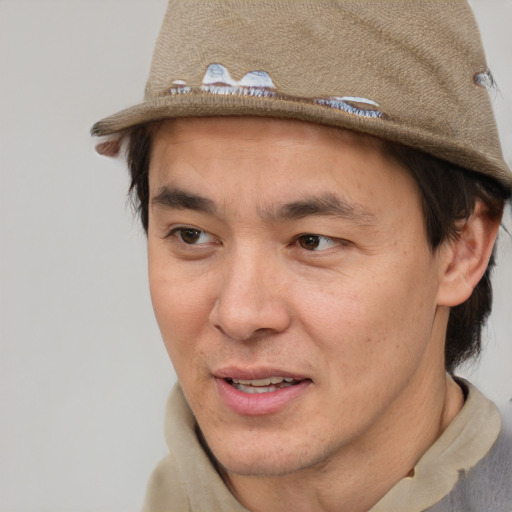 Joyful asian adult male with short  brown hair and brown eyes
