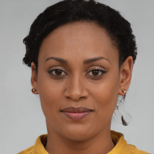 Joyful black young-adult female with short  brown hair and brown eyes