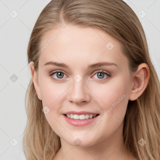 Joyful white young-adult female with long  brown hair and blue eyes