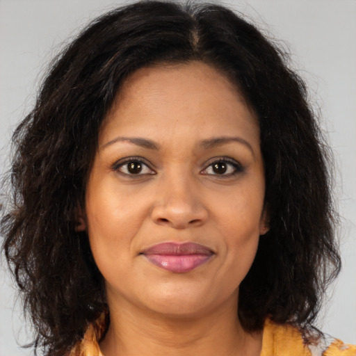 Joyful black adult female with medium  brown hair and brown eyes