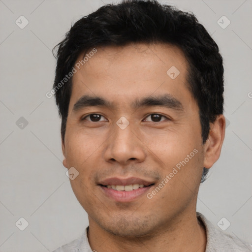 Joyful asian young-adult male with short  black hair and brown eyes