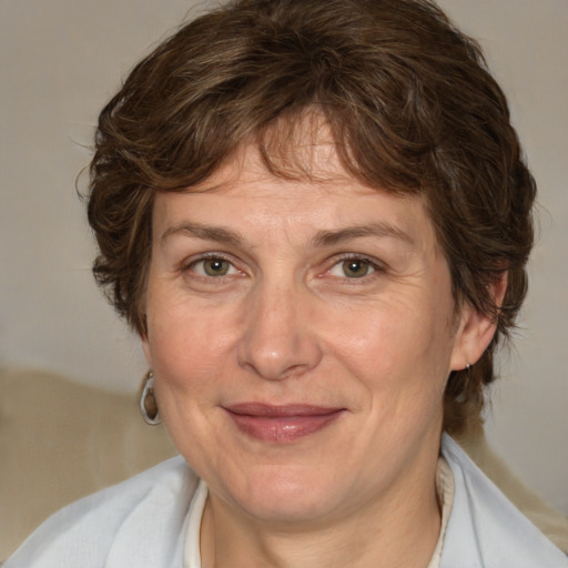 Joyful white adult female with medium  brown hair and green eyes