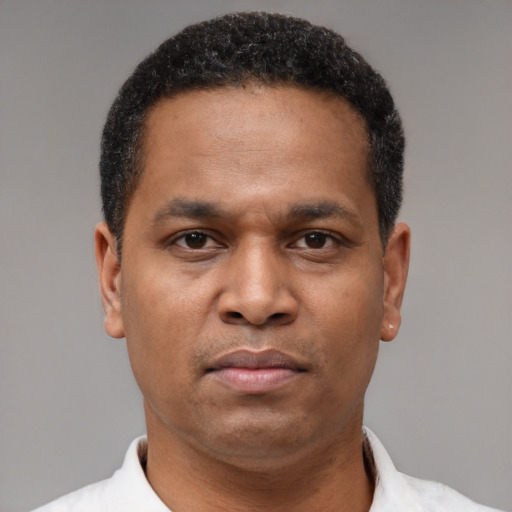 Neutral latino adult male with short  brown hair and brown eyes