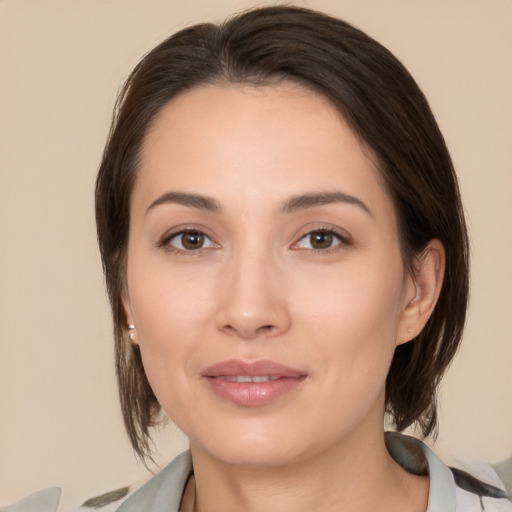 Joyful white young-adult female with medium  brown hair and brown eyes