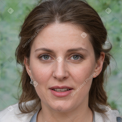 Joyful white adult female with medium  brown hair and blue eyes