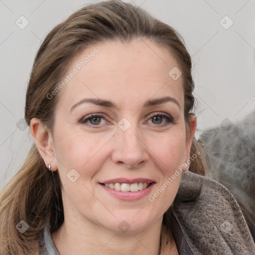 Joyful white adult female with medium  brown hair and grey eyes