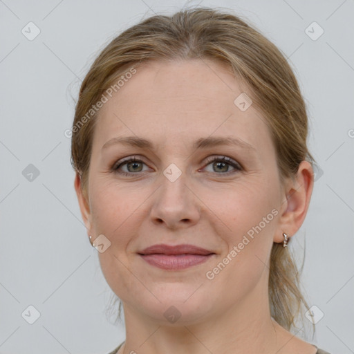 Joyful white young-adult female with medium  brown hair and grey eyes