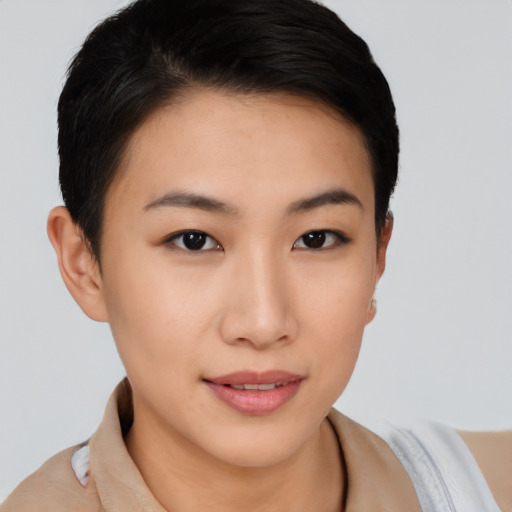 Joyful asian young-adult female with short  brown hair and brown eyes