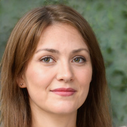 Joyful white young-adult female with long  brown hair and green eyes