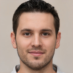 Joyful white young-adult male with short  brown hair and brown eyes