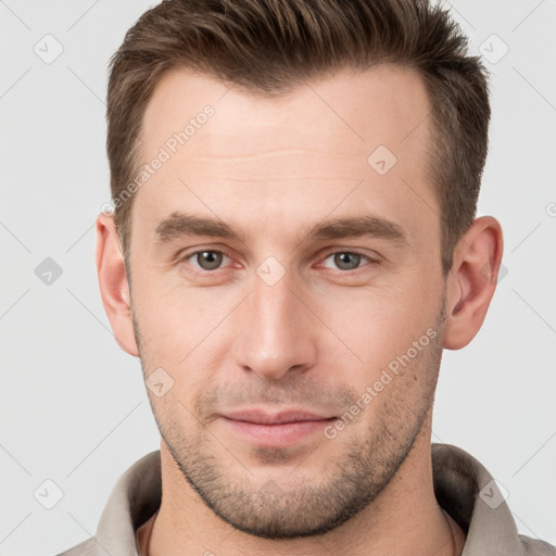 Joyful white young-adult male with short  brown hair and brown eyes