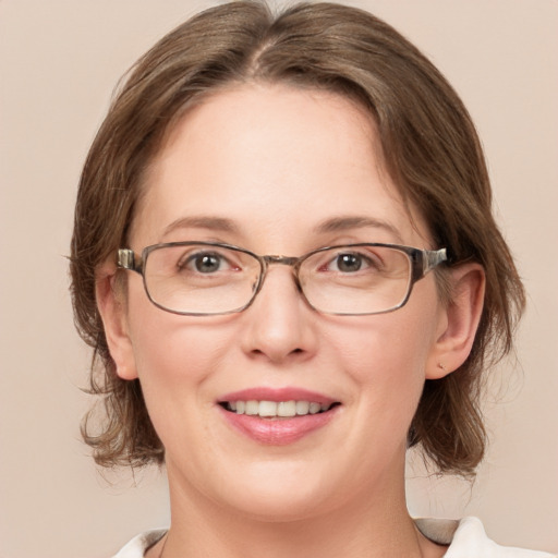 Joyful white adult female with medium  brown hair and grey eyes