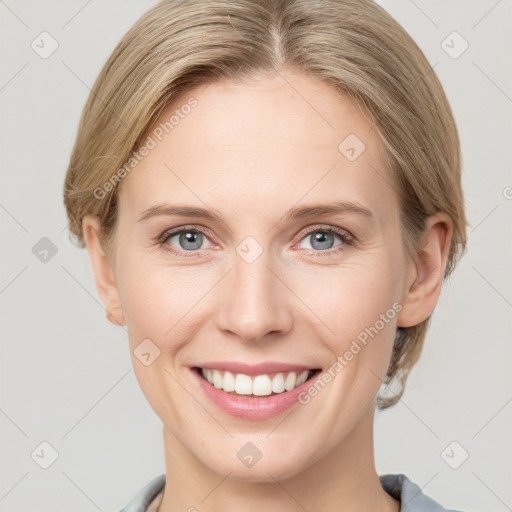 Joyful white young-adult female with short  brown hair and grey eyes