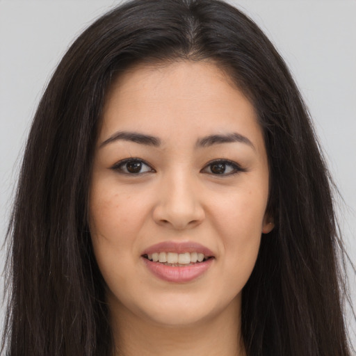 Joyful asian young-adult female with long  brown hair and brown eyes
