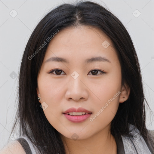 Joyful asian young-adult female with long  brown hair and brown eyes