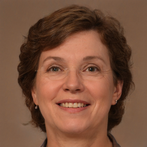 Joyful white adult female with medium  brown hair and green eyes