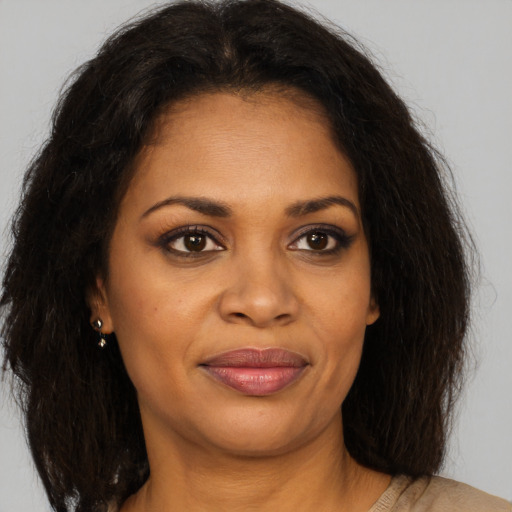 Joyful black young-adult female with medium  brown hair and brown eyes