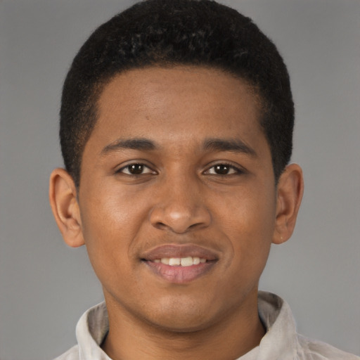 Joyful latino young-adult male with short  brown hair and brown eyes