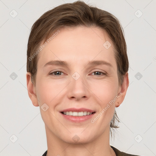 Joyful white young-adult female with short  brown hair and grey eyes