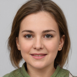 Joyful white young-adult female with medium  brown hair and green eyes