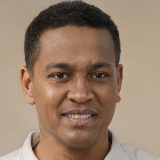 Joyful latino young-adult male with short  brown hair and brown eyes