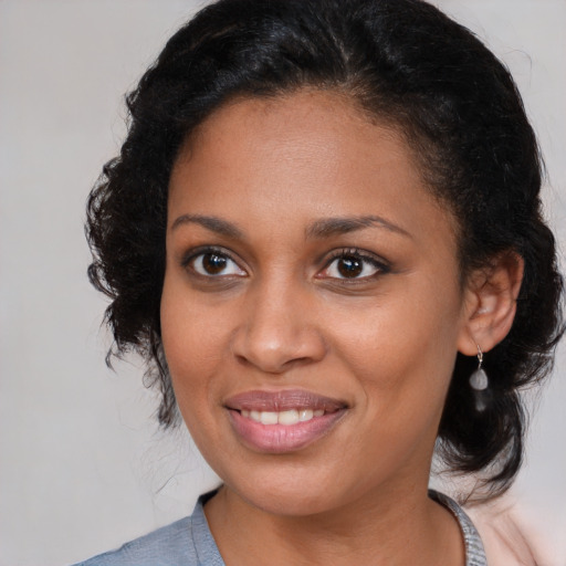Joyful black young-adult female with medium  brown hair and brown eyes
