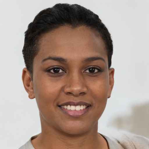 Joyful black young-adult female with short  brown hair and brown eyes