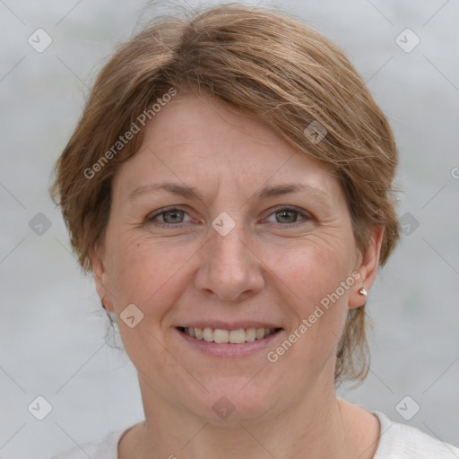 Joyful white adult female with medium  brown hair and grey eyes