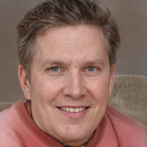 Joyful white adult male with short  brown hair and grey eyes