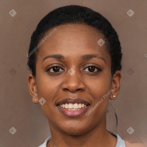 Joyful black young-adult female with short  brown hair and brown eyes