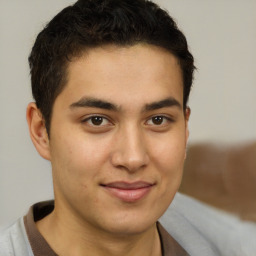 Joyful latino young-adult male with short  brown hair and brown eyes