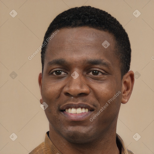 Joyful black young-adult male with short  black hair and brown eyes