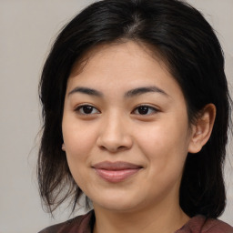 Joyful asian young-adult female with medium  brown hair and brown eyes