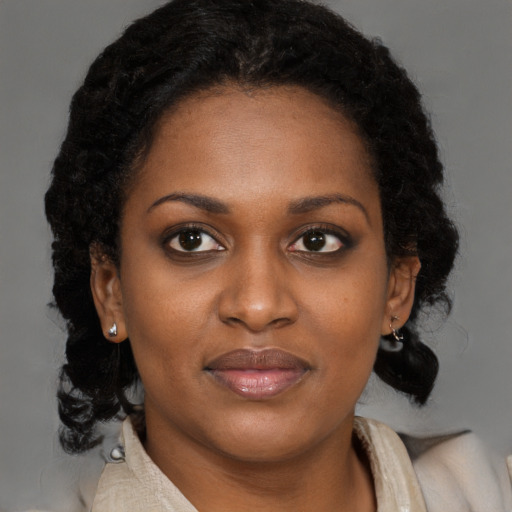 Joyful black young-adult female with medium  brown hair and brown eyes
