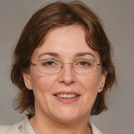 Joyful white adult female with medium  brown hair and blue eyes