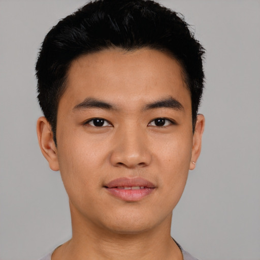 Joyful asian young-adult male with short  black hair and brown eyes