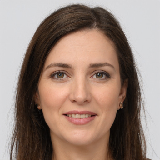 Joyful white young-adult female with long  brown hair and grey eyes