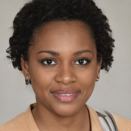 Joyful black young-adult female with short  brown hair and brown eyes