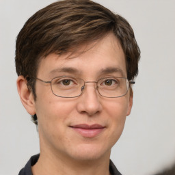 Joyful white adult male with short  brown hair and grey eyes