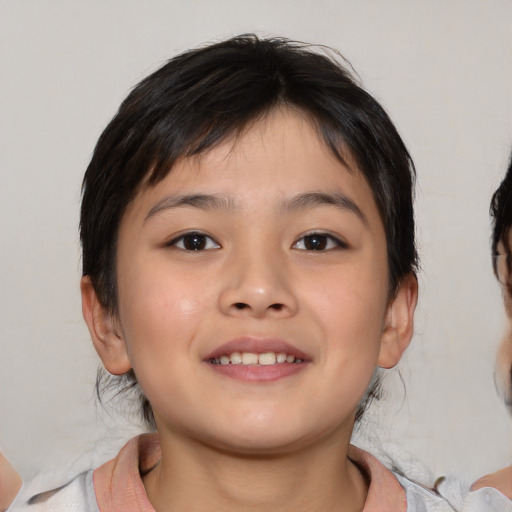 Joyful asian child female with medium  brown hair and brown eyes