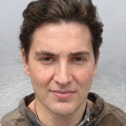 Joyful white adult male with short  brown hair and grey eyes