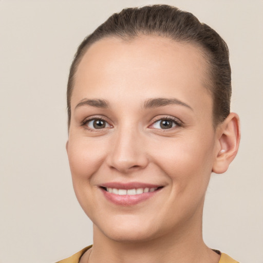 Joyful white young-adult female with short  brown hair and brown eyes