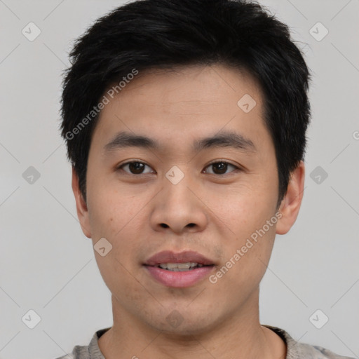 Joyful asian young-adult male with short  black hair and brown eyes