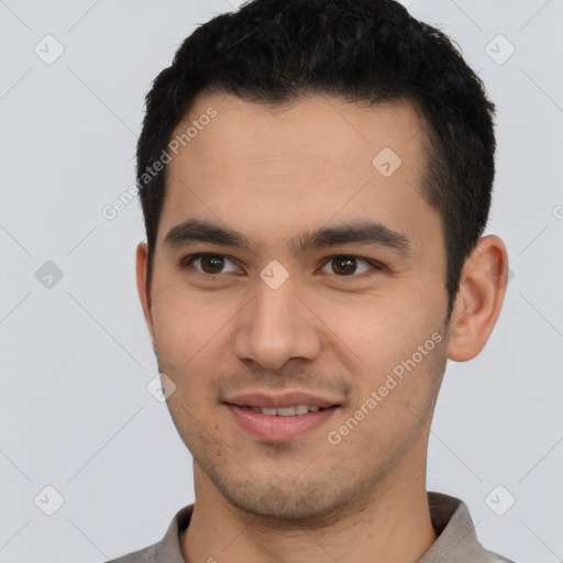 Joyful latino young-adult male with short  brown hair and brown eyes