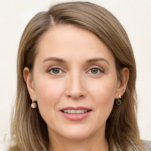 Joyful white young-adult female with long  brown hair and grey eyes