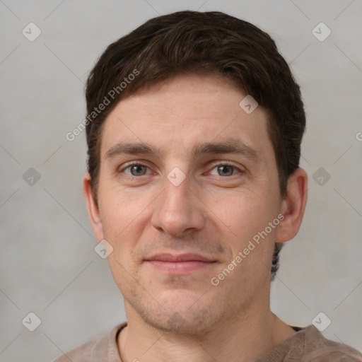 Joyful white adult male with short  brown hair and grey eyes