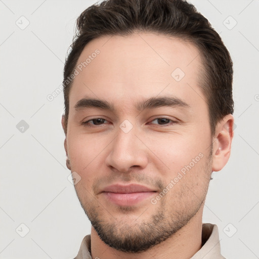 Joyful white young-adult male with short  brown hair and brown eyes