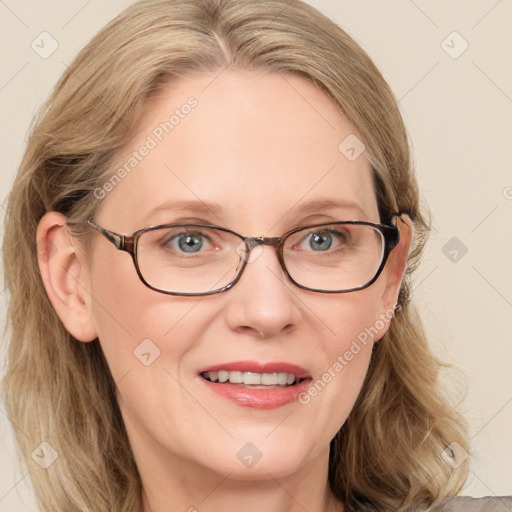 Joyful white adult female with medium  brown hair and blue eyes