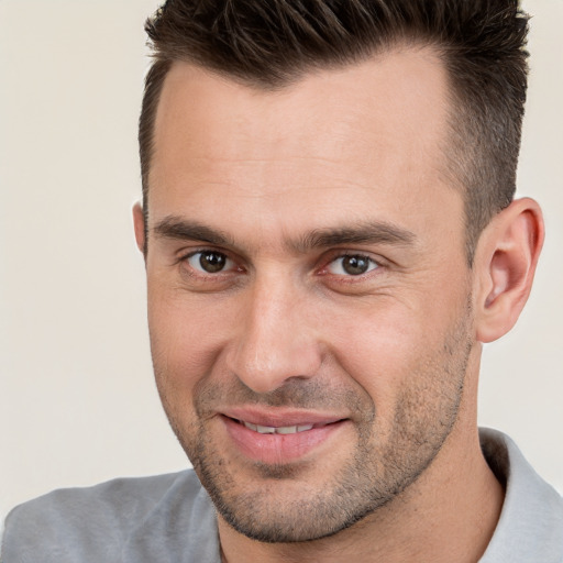 Joyful white adult male with short  brown hair and brown eyes