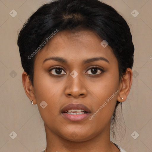 Joyful black young-adult female with short  brown hair and brown eyes
